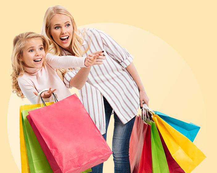 Woman and girl with colorful shopping bags
